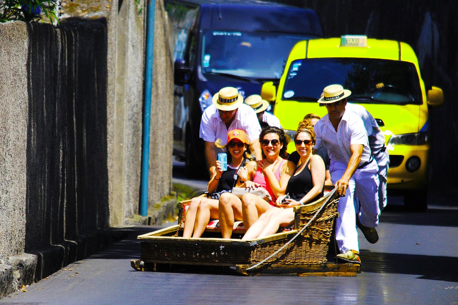 How to ride in toboggan wooden sledge down asphalt road on Madeira